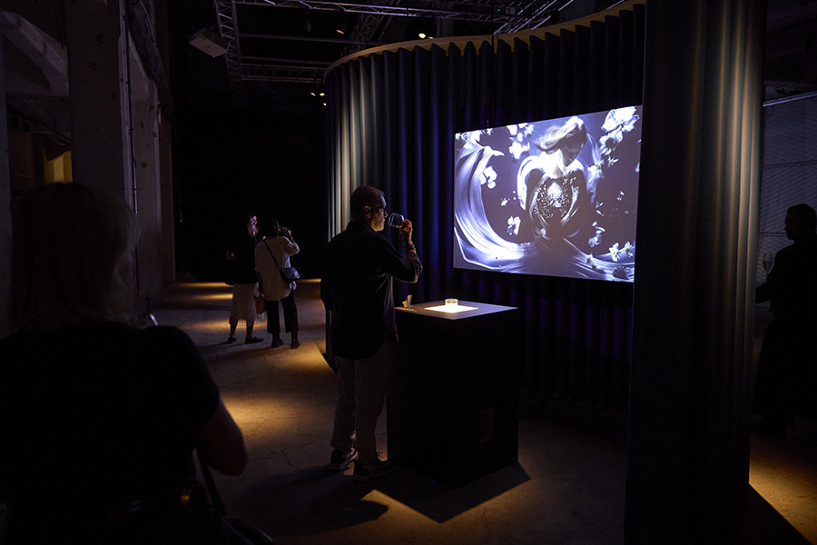 People smell the perfume inside the set up experience